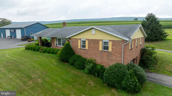 a living room with furniture a flat screen tv and a table