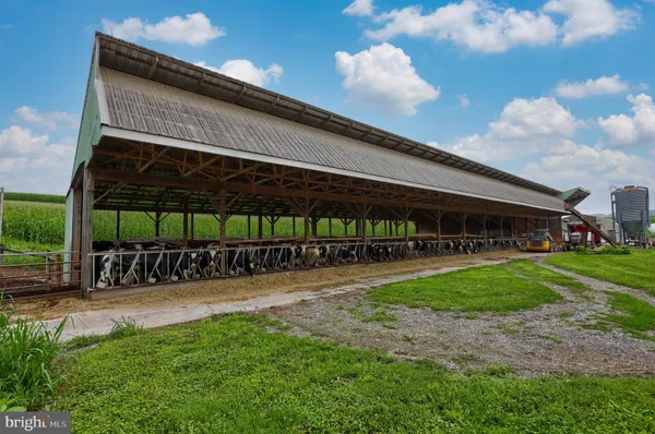 a living room with furniture a flat screen tv and a window