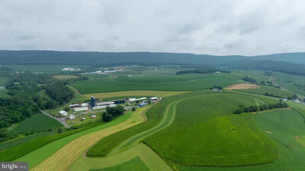 an aerial view of a golf course with a lake view