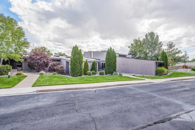 a view of a house with a yard and fence