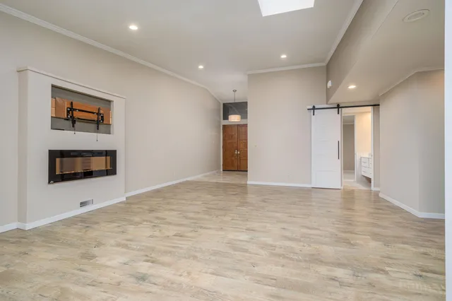 a view of an empty room with a fireplace