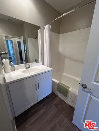 a spacious bathroom with a double vanity sink and a mirror
