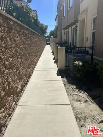 a pathway of a house with a yard