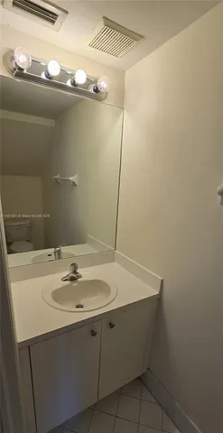 a bathroom with a sink and mirror