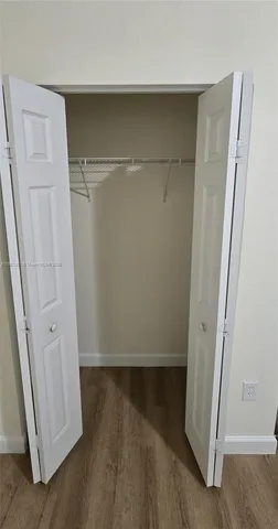 an empty room with wooden floor