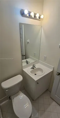 a bathroom with a sink a toilet and mirror