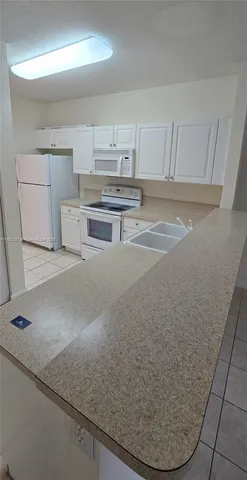 a room with a washing machine and cabinets