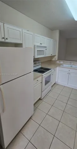 a kitchen with cabinets and appliances