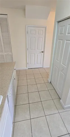 a view of an empty room and a hallway