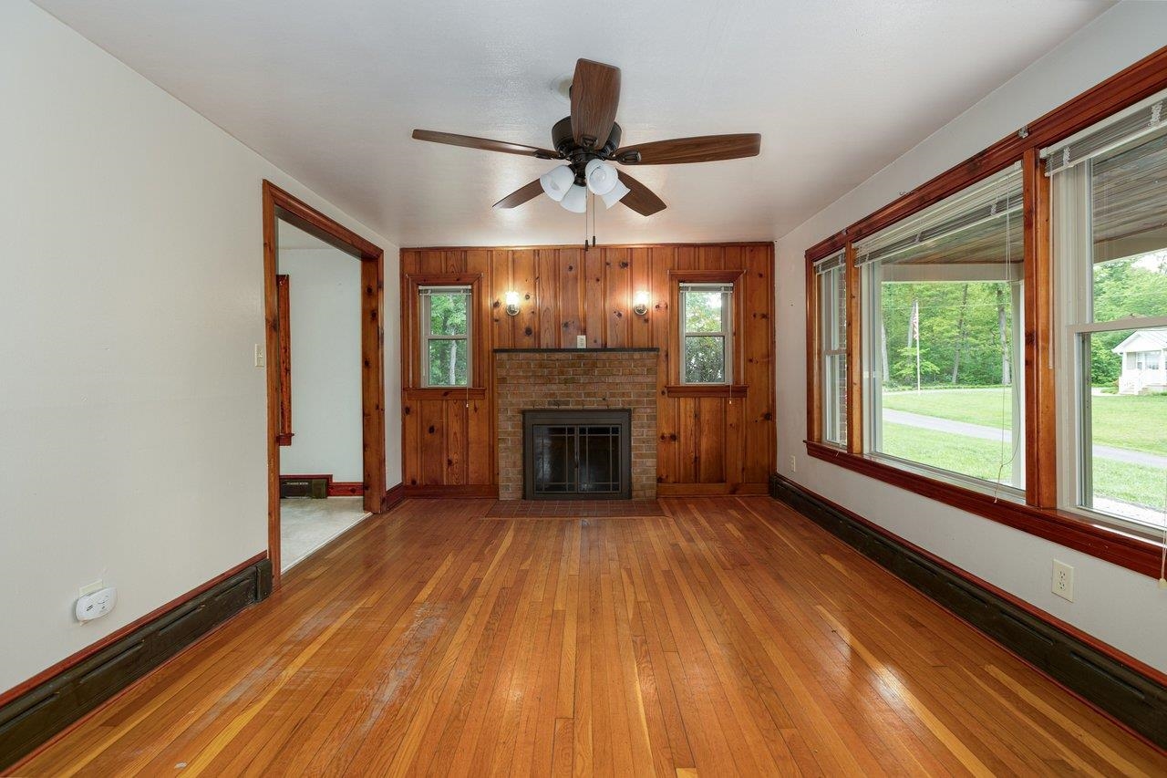 547 Grindstone Road Bridgewater, VA 22812 - Photo 5 of 57 a view of a livingroom with a fireplace a ceiling fan and wooden floor