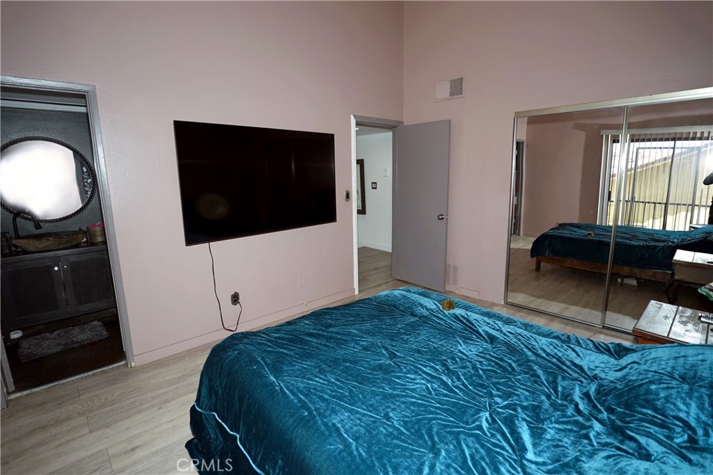 18954 Sherman Way, Unit 3 Reseda, CA 91335 - Photo 20 of 46 a bedroom with a bed and a flat tv screen on the dresser