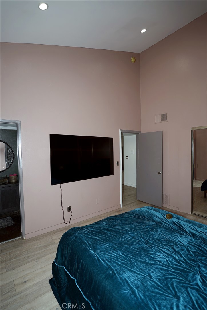 18954 Sherman Way, Unit 3 Reseda, CA 91335 - Photo 21 of 46 a bedroom with a bed and a flat screen tv