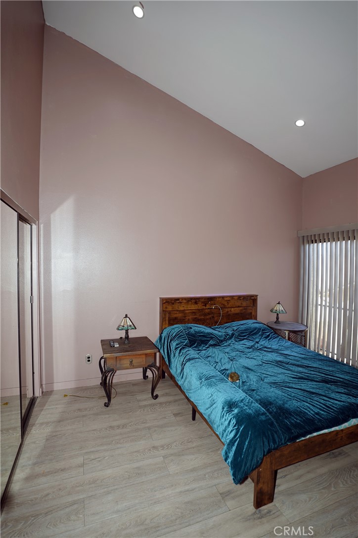 18954 Sherman Way, Unit 3 Reseda, CA 91335 - Photo 22 of 46 a bedroom with a bed and wooden floor
