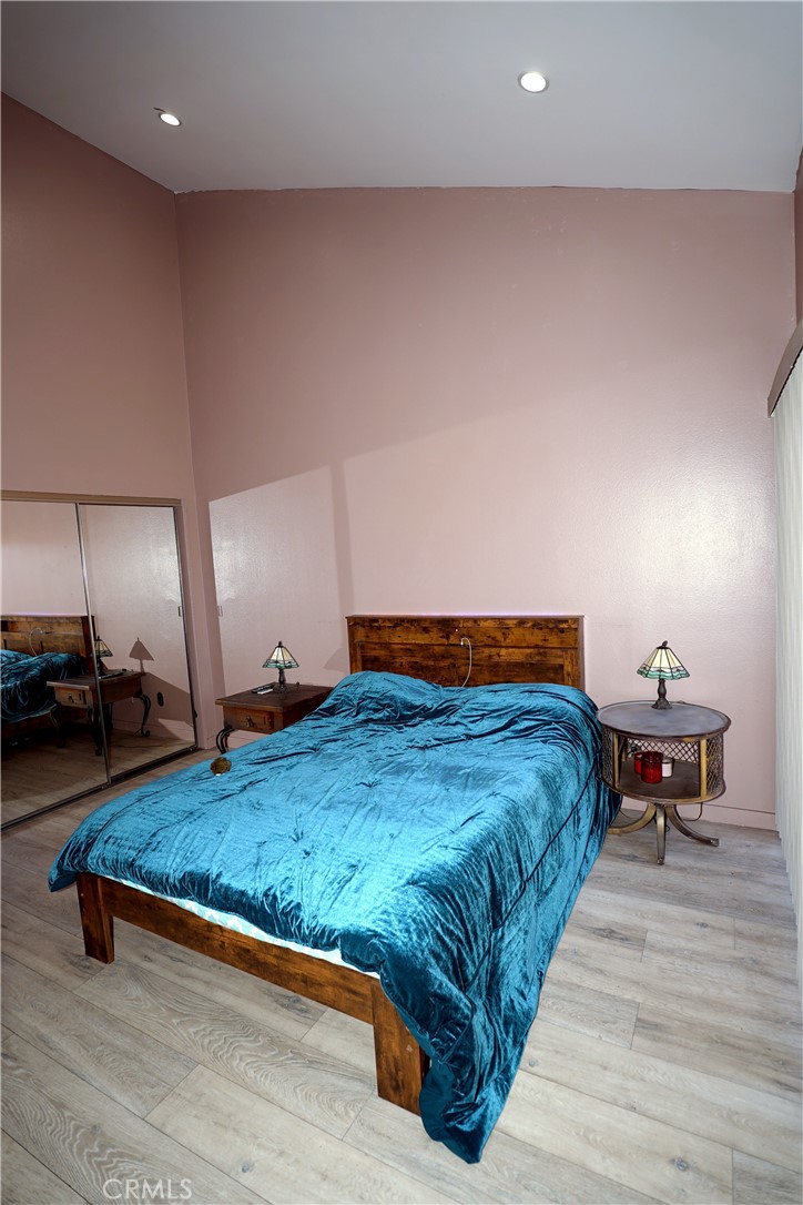 18954 Sherman Way, Unit 3 Reseda, CA 91335 - Photo 23 of 46 a bedroom with a bed and wooden floor