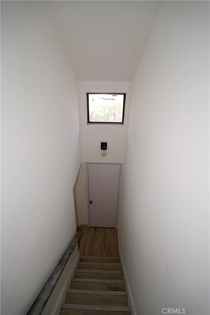 18954 Sherman Way, Unit 3 Reseda, CA 91335 - Photo 42 of 46 a view of a hallway with wooden floor and a window