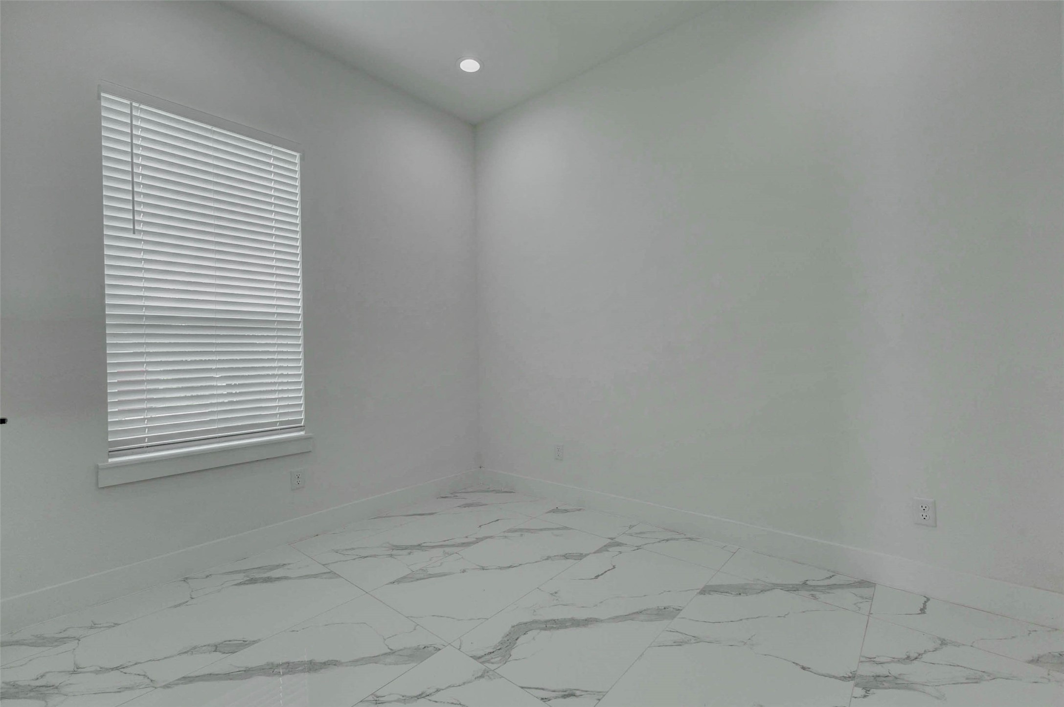 5705 Elysium Street Houston, TX 77091 - Photo 5 of 22 A bright upstairs room offers neutral finishes, window coverings, recessed lighting, and flexible space that could serve as a bedroom, home office, guest room, or creative area.