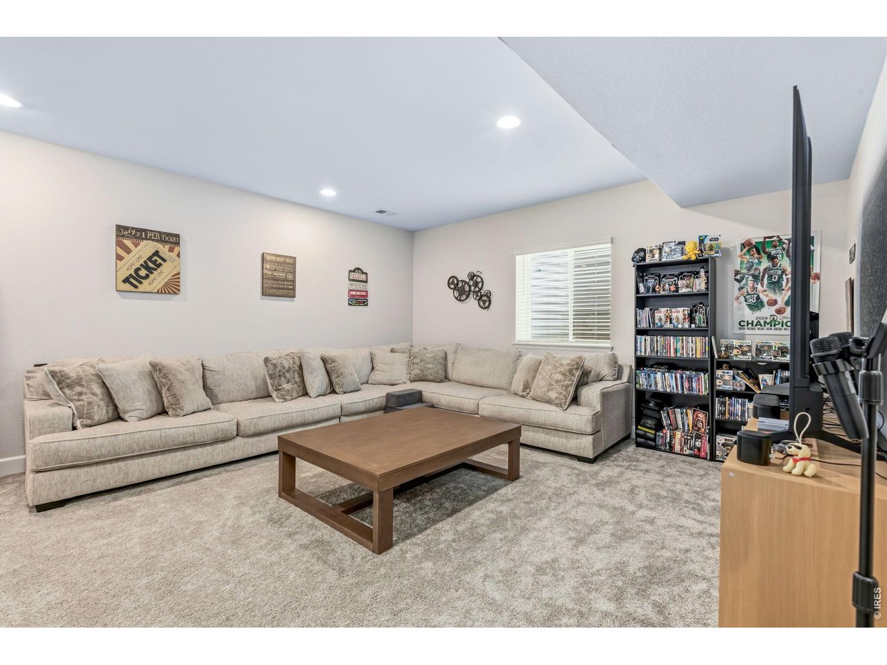 955 Rustling Street Windsor, CO 80550 - Photo 23 of 34 a living room with furniture and a flat screen tv