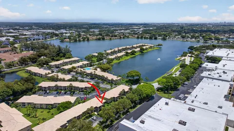 an aerial view of lake and residential houses with outdoor space