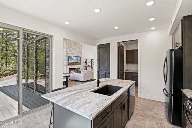 a kitchen with stainless steel appliances granite countertop sink refrigerator and stove