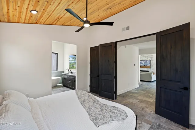 a bathroom with a granite countertop sink and a large mirror