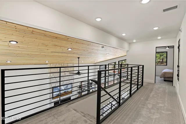 a large bed sitting in a bedroom next to a window