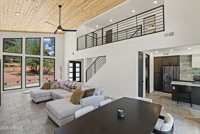a living room with furniture and large window