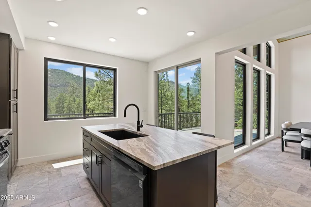 a kitchen with a sink and large window