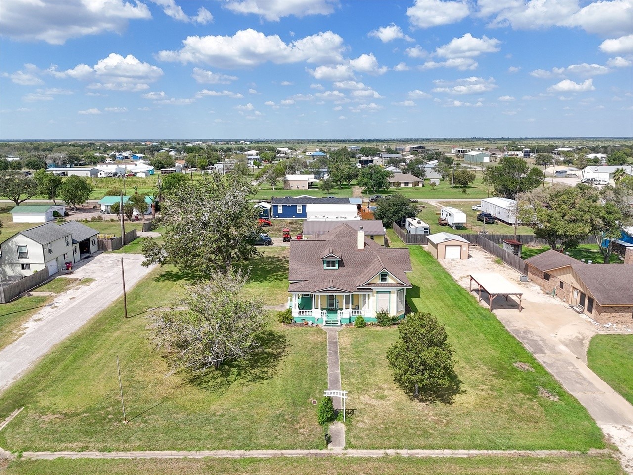 an aerial view of residential houses with outdoor space and street view