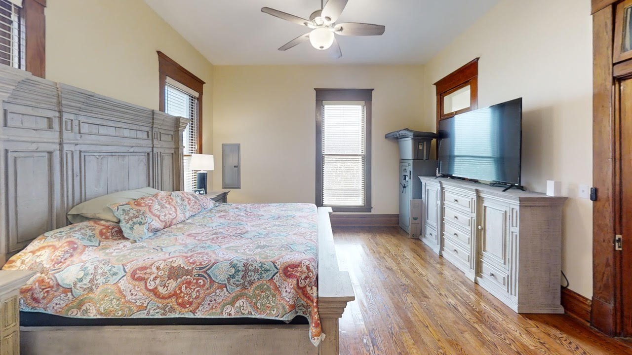 570 Wightman Street Matagorda, TX 77457 - Photo 17 of 29 a bedroom with a bed and a flat screen tv