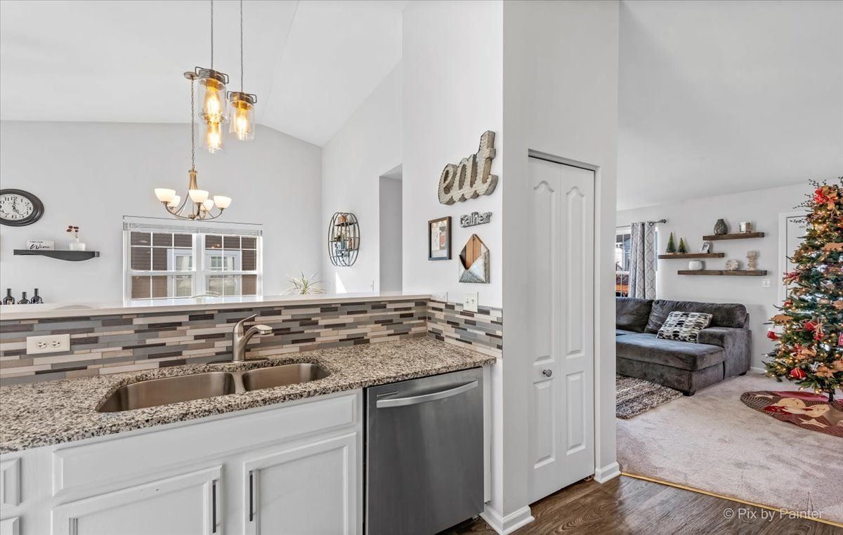 2464 Golf Ridge Circle, Unit 2464 Naperville, IL 60563 - Photo 14 of 28 a kitchen with granite countertop a sink stove and cabinets