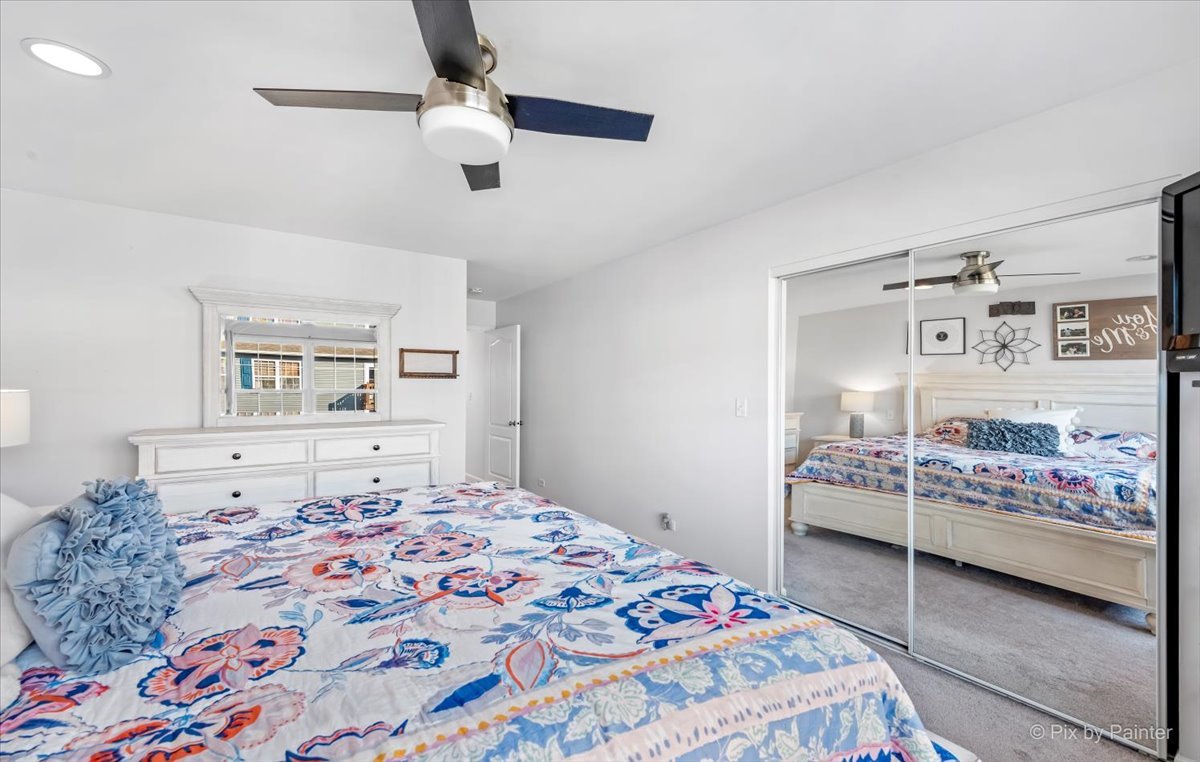2464 Golf Ridge Circle, Unit 2464 Naperville, IL 60563 - Photo 19 of 28 a bedroom with a bed and a lamp on dresser