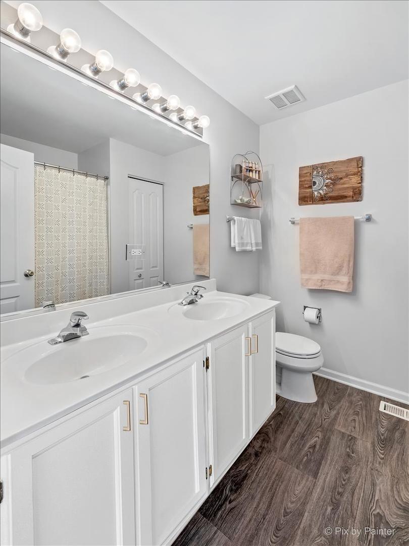 2464 Golf Ridge Circle, Unit 2464 Naperville, IL 60563 - Photo 20 of 28 a spacious bathroom with a double vanity sink and a mirror
