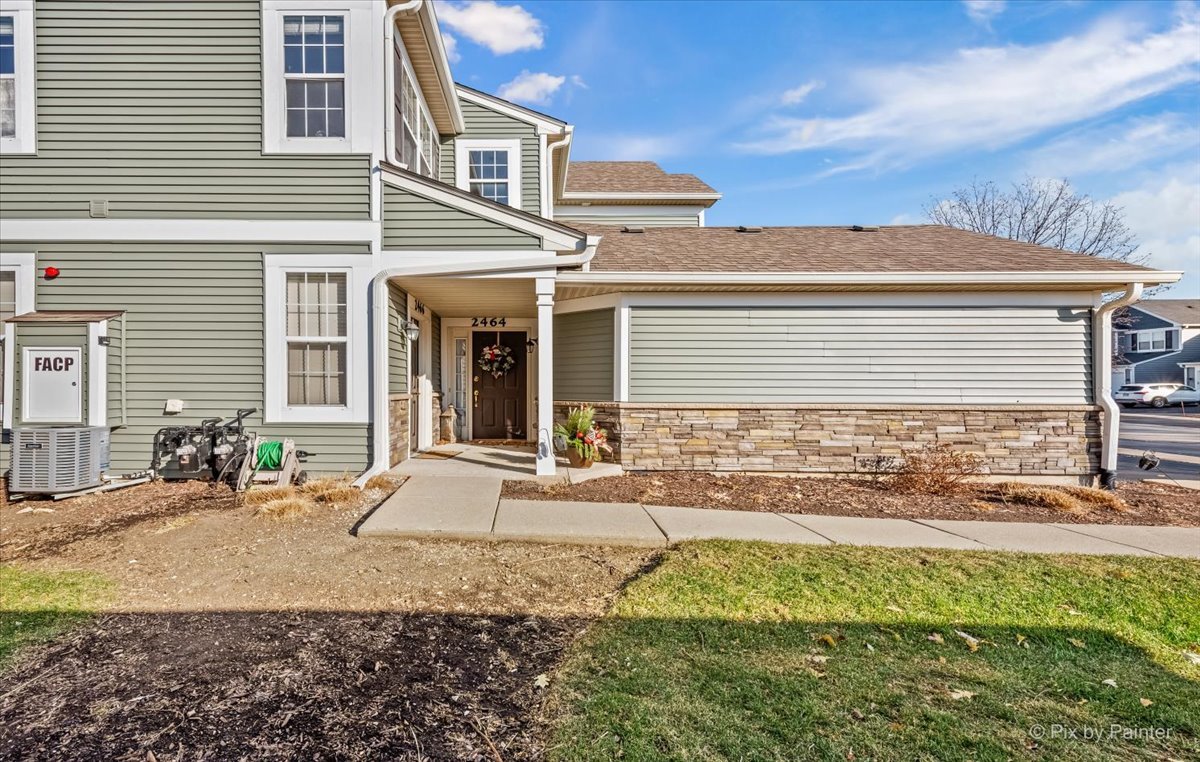 2464 Golf Ridge Circle, Unit 2464 Naperville, IL 60563 - Photo 3 of 28 a front view of a house with garden