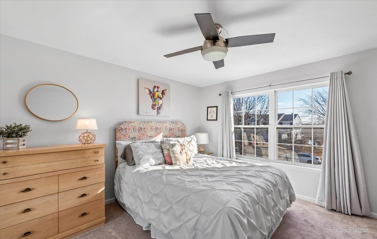 2464 Golf Ridge Circle, Unit 2464 Naperville, IL 60563 - Photo 21 of 28 a bedroom with a large bed and a large window