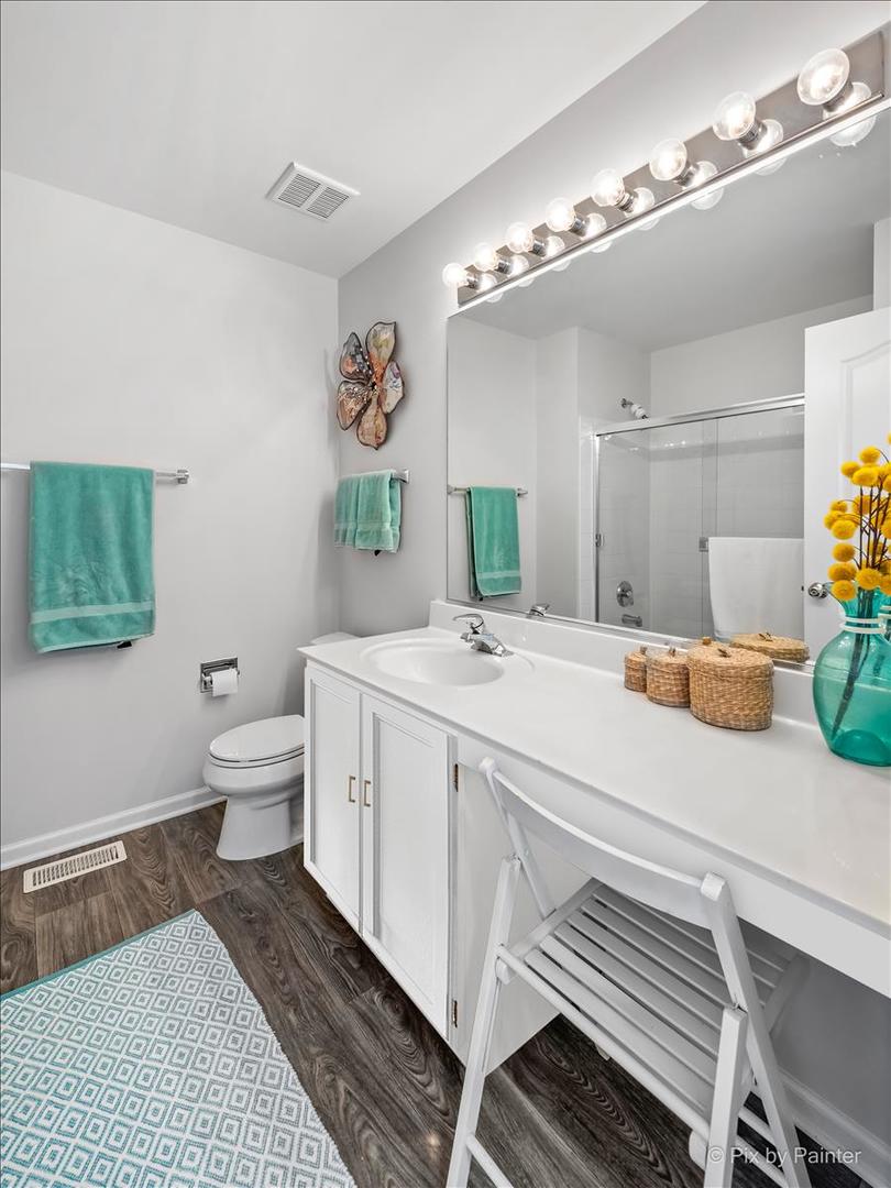 2464 Golf Ridge Circle, Unit 2464 Naperville, IL 60563 - Photo 23 of 28 a spacious bathroom with a double vanity sink mirror and toilet