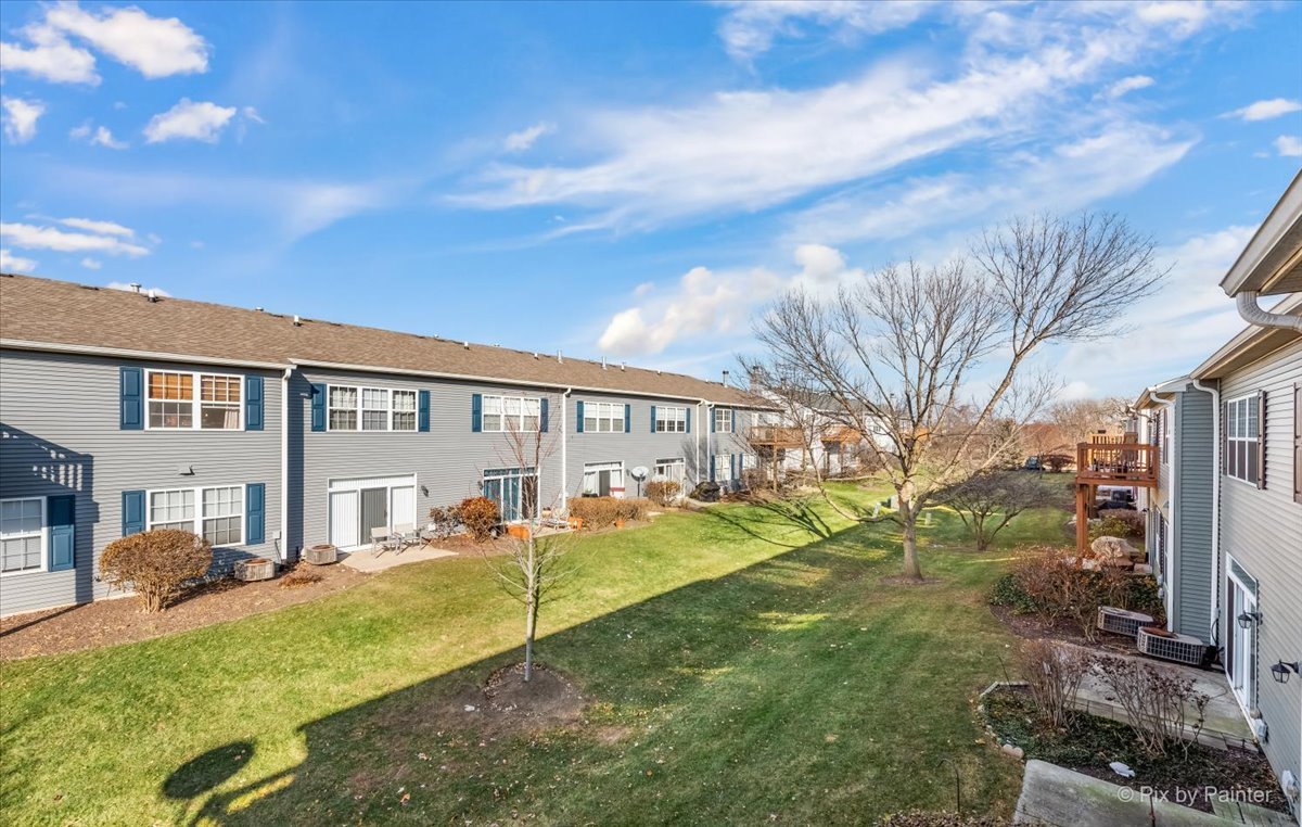 2464 Golf Ridge Circle, Unit 2464 Naperville, IL 60563 - Photo 26 of 28 a view of a house with a yard