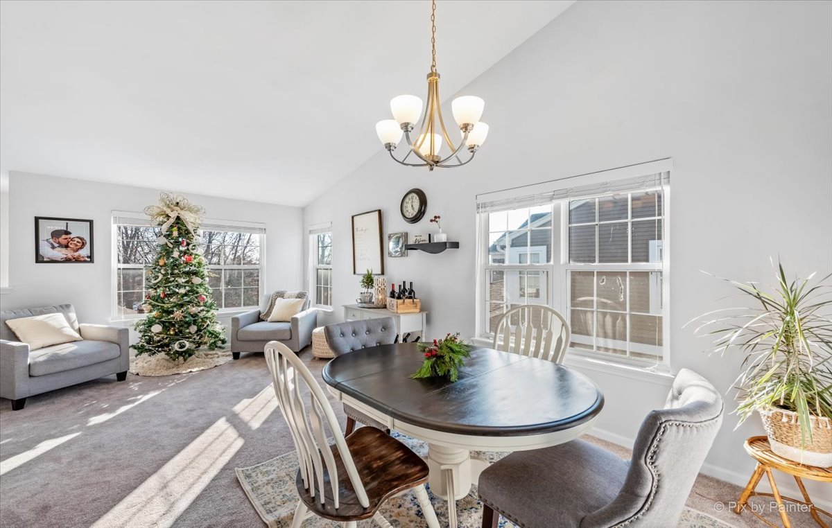 2464 Golf Ridge Circle, Unit 2464 Naperville, IL 60563 - Photo 8 of 28 a view of a dining room with furniture wooden floor and chandelier