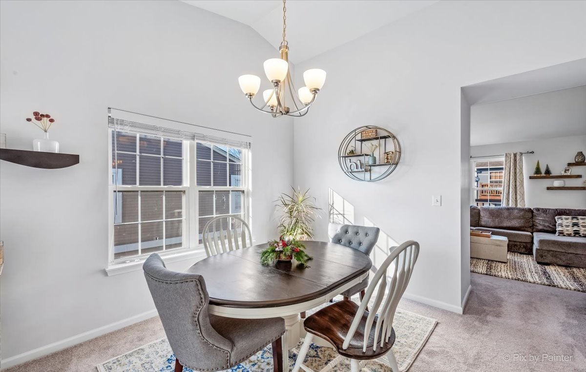 2464 Golf Ridge Circle, Unit 2464 Naperville, IL 60563 - Photo 9 of 28 a dining room with furniture a potted plant and wooden floor