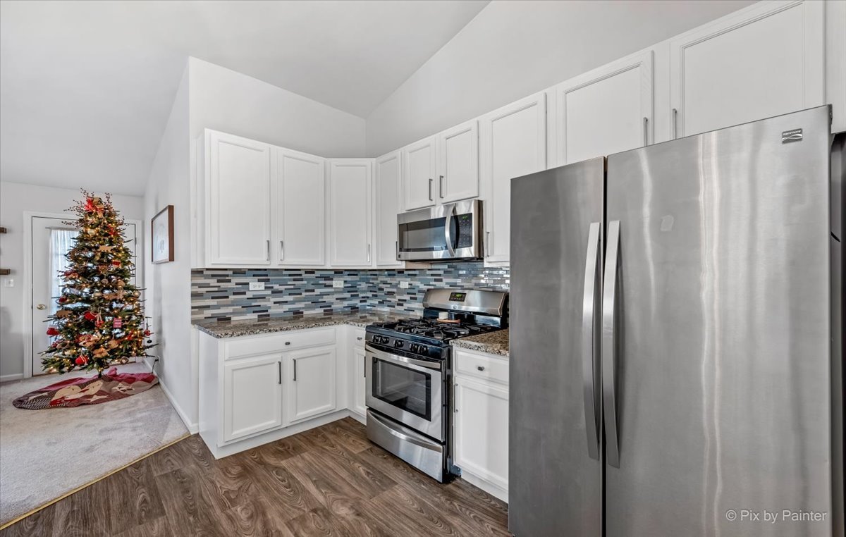 2464 Golf Ridge Circle, Unit 2464 Naperville, IL 60563 - Photo 10 of 28 a kitchen with stainless steel appliances granite countertop a refrigerator and a stove