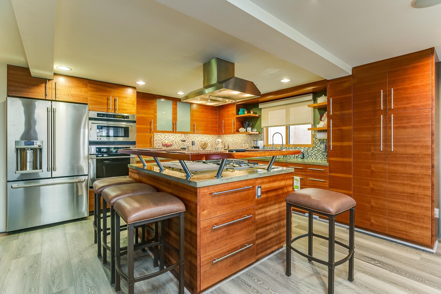 144 Pasadena Avenue Oxnard, CA 93035 - Photo 13 of 42 a kitchen with stainless steel appliances granite countertop a stove and a refrigerator