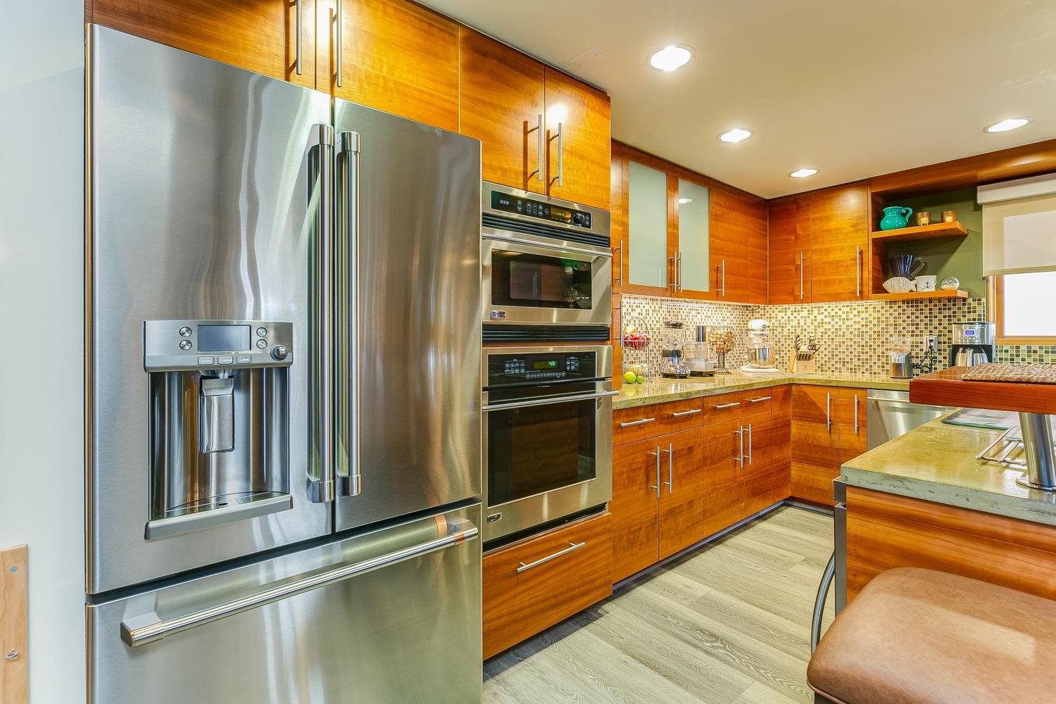 144 Pasadena Avenue Oxnard, CA 93035 - Photo 18 of 42 a kitchen with stainless steel appliances granite countertop a refrigerator and a stove top oven