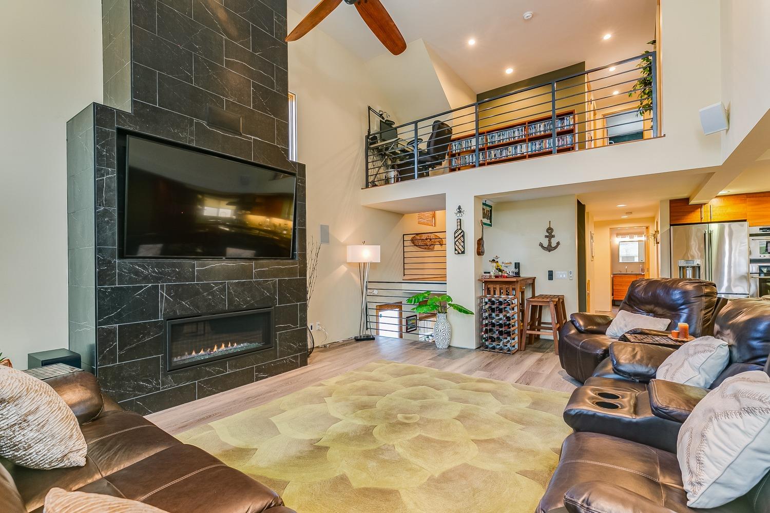 144 Pasadena Avenue Oxnard, CA 93035 - Photo 6 of 42 a living room with furniture a flat screen tv and a fireplace