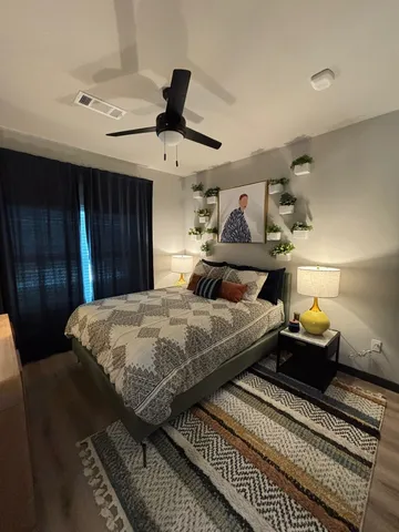 a bedroom with bed and wooden floor