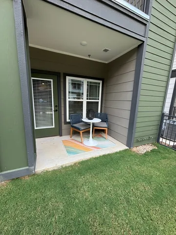 a view of a backyard with table and chairs with wooden floor and fence