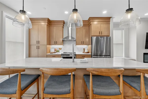a kitchen with stainless steel appliances granite countertop a sink refrigerator and cabinets