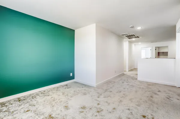 a view of a big room with closet and windows