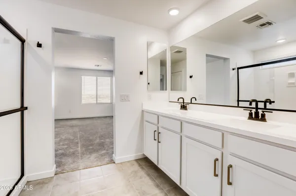 a bathroom with a double vanity sink mirror and