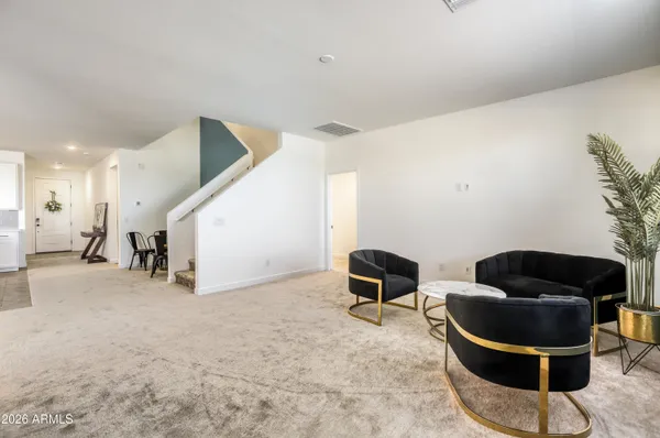 a living room with furniture and a chair