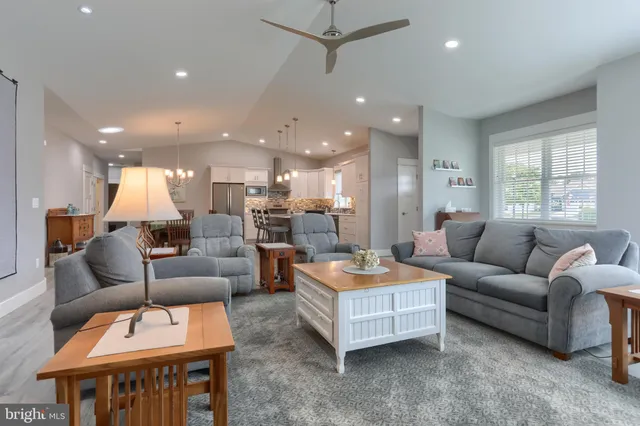 a living room with furniture kitchen view and a table