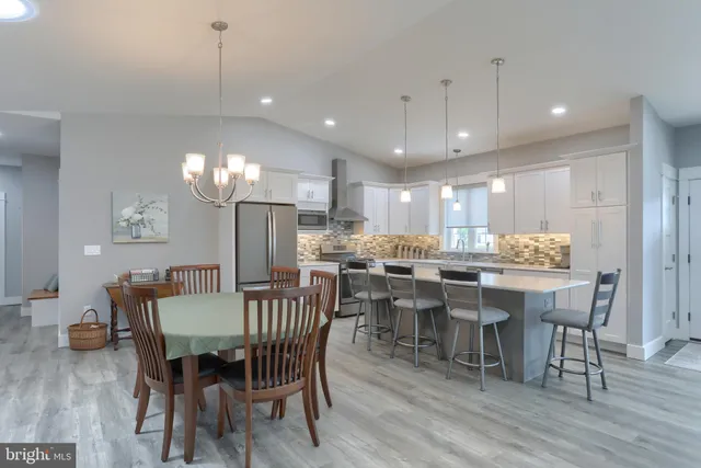 a view of a dining room with furniture wooden floor and chandelier